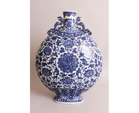 A LARGE CHINESE BLUE & WHITE PORCELAIN MOON FLASK, each domed side decorated in 'heaped and piled' effect, each centred by an