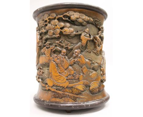 A CHINESE BAMBOO STYLE BRUSHPOT, incorporating a fixed stand, the sides decorated in relief with a continuous scene of sages 