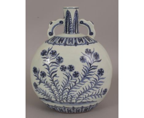 A CHINESE MING STYLE BLUE & WHITE PORCELAIN MOON FLASK, each domed side decorated with extending foliage, the base unglazed, 