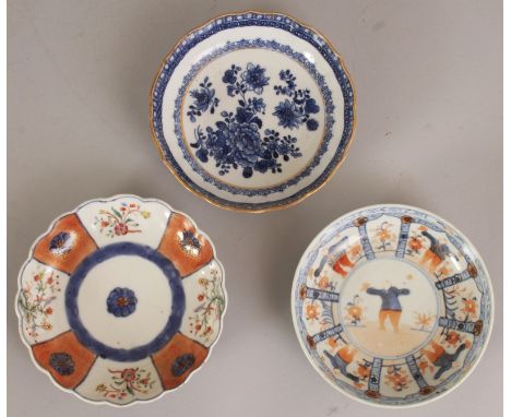 A GROUP OF THREE 18TH CENTURY CHINESE PORCELAIN SAUCERS, various palettes and designs, the largest 5in diameter. (3)