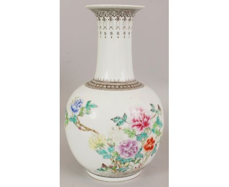 A 20TH CENTURY CHINESE FAMILLE ROSE PORCELAIN BOTTLE VASE, painted with calligraphy and a floral arrangement, 11.6in high.