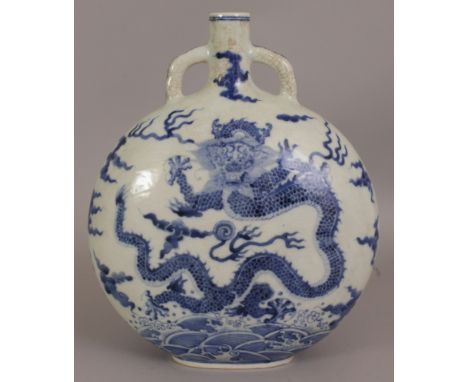 A CHINESE BLUE & WHITE PORCELAIN DRAGON MOON FLASK, each domed surface decorated with a dragon amidst flame and cloud scrolls