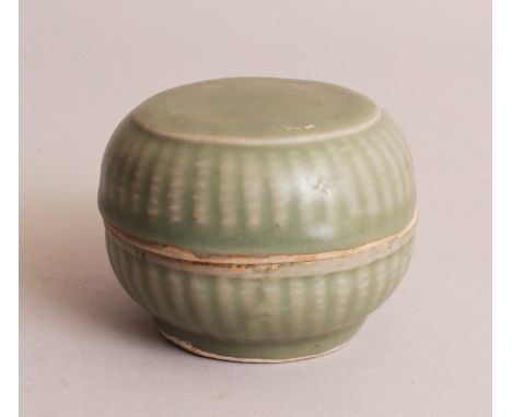 A CHINESE SONG DYNASTY CELADON GLAZED CERAMIC BOX & COVER, each section with fluted sides, 3.5in diameter.
