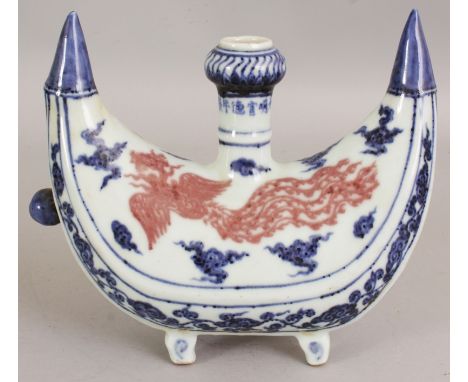 AN UNUSUAL MING STYLE ISLAMIC MARKET UNDERGLAZE-BLUE & COPPER RED PILGRIMS FLASK, of crescent form and decorated with phoenix