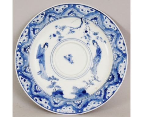 A CHINESE KANGXI MARK & PERIOD BLUE & WHITE PORCELAIN CUP STAND, circa 1700, painted with 'long eliza', rockwork and overhang