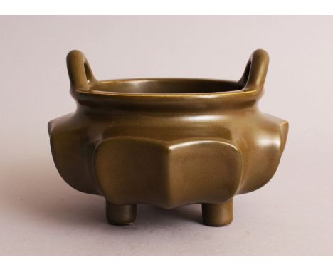 A CHINESE GREEN TEA DUST PORCELAIN TRIPOD CENSER, with concave lobed sides, the base with a Qianlong seal mark, 5.6in wide at