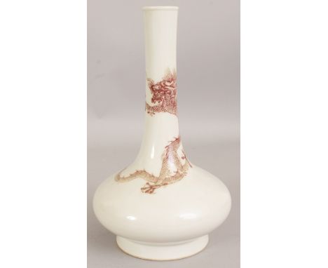 A CHINESE COPPER RED PORCELAIN BOTTLE VASE, the neck decorated with a sinuous dragon, the base with a six-character Kangxi ma