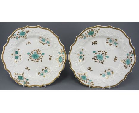 A pair of early nineteenth century porcelain hand-painted Ridgway moulded dessert plates, c. 1820-30.  Each is decorated with