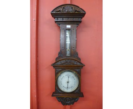 A Victorian carved walnut aneroid barometer, the silvered dial signed Grey &amp; Selby, Nottingham