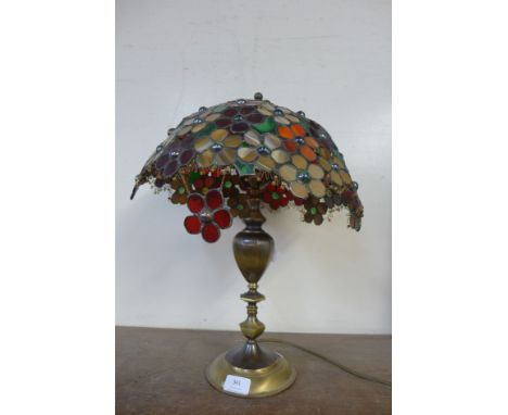 A brass table lamp and a multi-coloured glass shade, a/f