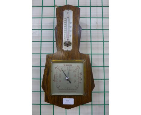An Art Deco oak aneroid barometer/thermometer