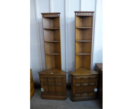 Two Ercol corner cabinets