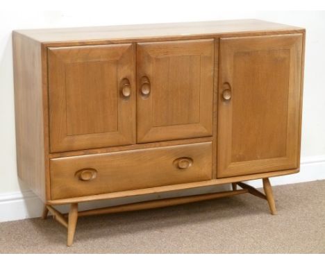 Ercol golden elm sideboard fitted with three cupboards and single drawer, W114cm, H82cm, D44cm