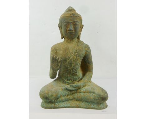 A KHMER BRONZE BUDDHA circa 1800, remains of consecration clay to base, 22.5cm high 
