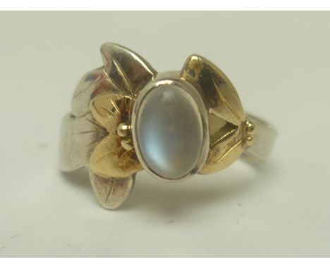 AN ART NOUVEAU DESIGN GOLD MOUNTED SILVER AND MOONSTONE SET RING, size L and half 