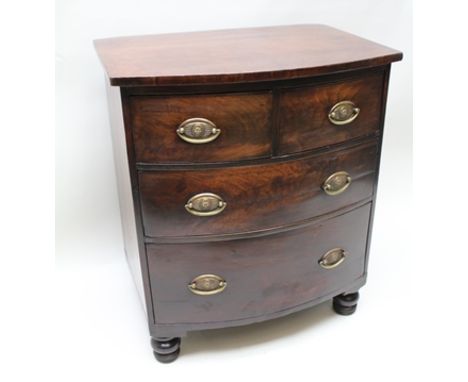 A 19TH CENTURY MAHOGANY FINISHED BOW FRONT CONVERTED COMMODE, having plain top with two inline drawers, over two graduating f