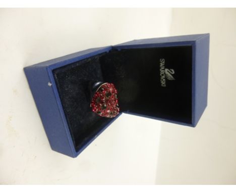 SWAROVSKI A SILVER COLOURED METAL AND HEART SHAPED MULTI-CRYSTAL DRESS RING, set with a multitude of two shades of red colour