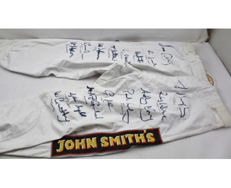 A PAIR OF RACING JOCKEY'S JODHPURS with "John Smiths" decals, autograph signed by amongst other jockeys; Tom Scudamore, John 