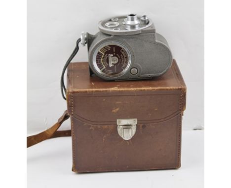 A "G.B. - BELL & HOWELL" 8mm CINE CAMERA, with booklet in leather case 