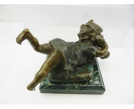 A LATE 20TH CENTURY PATINATED BRONZE, depicting a child lying upon a cushion, mounted upon a polished green veined marble pli