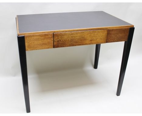 AN ART DECO DESIGN OAK FINISHED DESK with later textured insert top, having a plain frieze with single central drawer, suppor