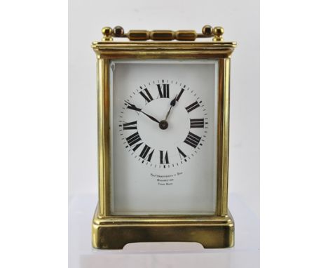 A LATE 19TH CENTURY BRASS CASED CARRIAGE CLOCK fitted bevelled glass panels and folding bale handle, French eight-day movemen
