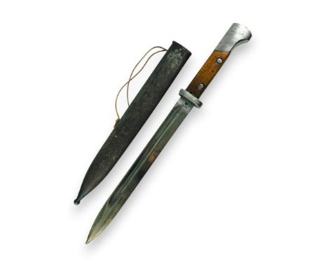 Bayonet with a single-edged blade, featuring a double-edged concave fuller. The bayonet's tang is single-sided. The handle ha