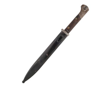 Bayonet with a single-edged blade, featuring a double-edged concave fuller. The bayonet's tang is single-sided. The handle ha