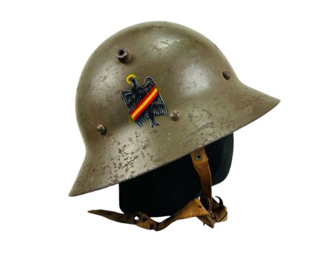 Czechoslovak vz.30 helmet with a Spanish paint scheme. The helmet includes a liner and chin strap.Overall condition as shown 