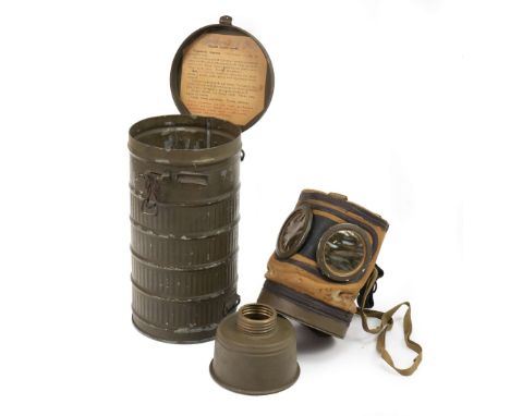 Pre-WW2 gas mask canister with strap and preserved paper instructions, along with the R.S.C. Model 24 gas mask, complete with