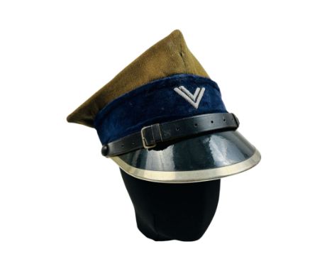 Infantry Visor Cap in the rank of Second Lieutenant. The crown is khaki, trimmed with white braid, and the band is blue. On t