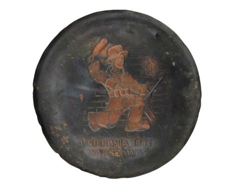 Round wall plaque of the Warsaw Uprising, embossed on a brass plate. The plaque depicts a young insurgent during the battle, 