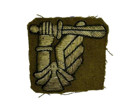 Identification patch of the 2nd Warsaw Armored Division in the form of an armored arm with a sword, embroidered in bullion th