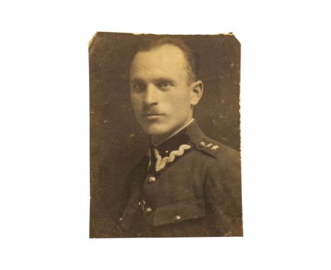 A pre-war photograph of a Polish Army lieutenant in a metal frame. According to family accounts, this individual was an aide-