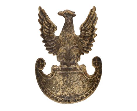 Polish cap eagle featuring an eagle with outstretched wings, sitting on an Amazon shield. The head is devoid of a crown. The 