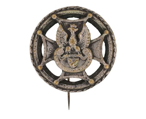 Badge of the Artillery Command of the Kraków Army. A round badge featuring an eagle in a crown with a cross, placed on a styl