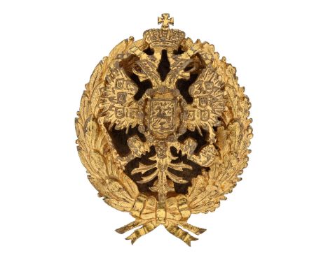 A badge in the form of a laurel wreath, with the Russian Imperial double-headed eagle placed at the center. Both the eagle an