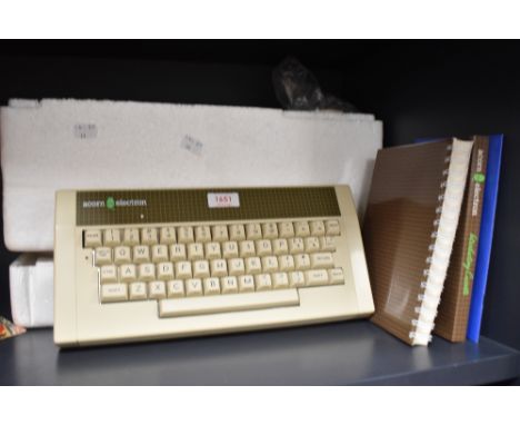 A vintage Acorn Electron computer including user guide and introductory cassette.