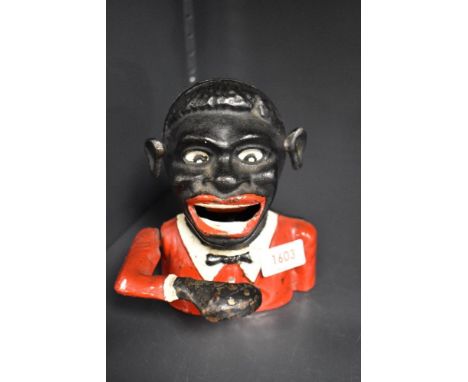A vintage cast metal Jolly Gent mechanical money box.