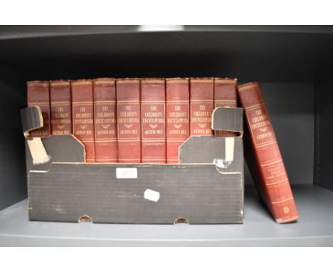 Ten red leather bound volumes of The Children's Encyclopedia by Arthur Mee