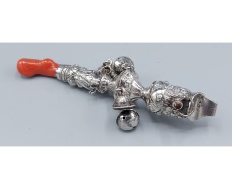 A 19th Century silver babies rattle, set with Coral, 14cms long