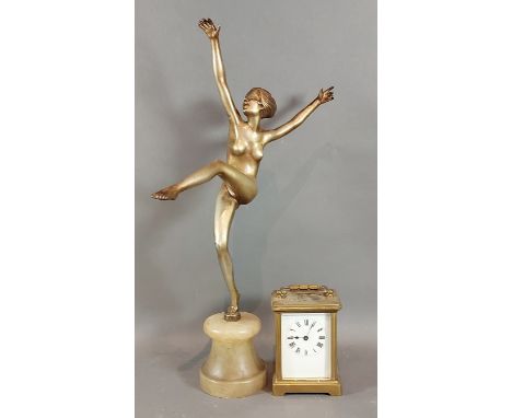 An Art Deco style figure in the form of a dancing girl together with a brass cased Carriage clock 