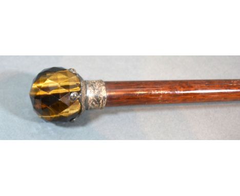 An early 20th century walking cane with silver mounted Tigers Eye handle, 91cms long