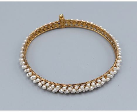A yellow metal seed Pearl set bangle, 6cms diameter, 11.9gms
