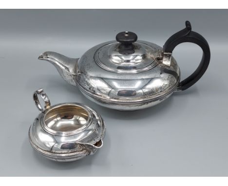A Sheffield silver teapot of melon form together with a matching cream jug, 25ozs