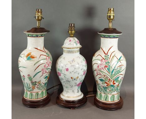 A Chinese style table lamp together with a similar pair of table lamps 