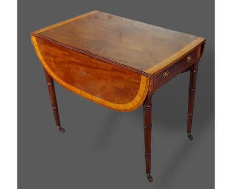 A 19th Century mahogany Pembroke table the drop flap top with wide Satinwood banding above a frieze drawer raised upon ring t