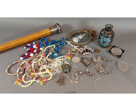 A small collection of jewellery to include silver brooches together with a silver topped walking cane 