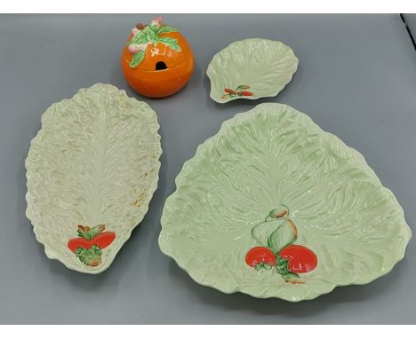 A Clarice Cliff preserve pot in the form of an Orange together with three Carlton Ware dishes in the form of leaves 