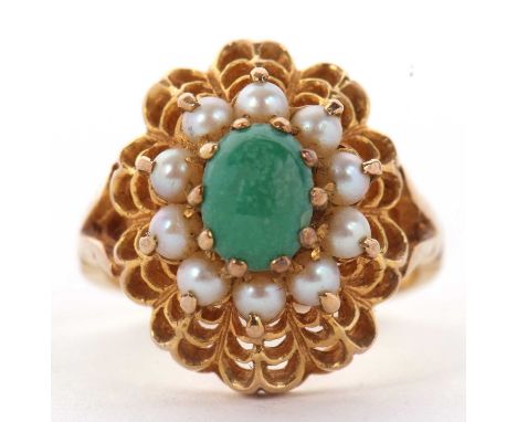 A 9ct turquoise and split pearl ring, the central oval turquoise cabochon surrounded by split pearls on a raised scalloped su